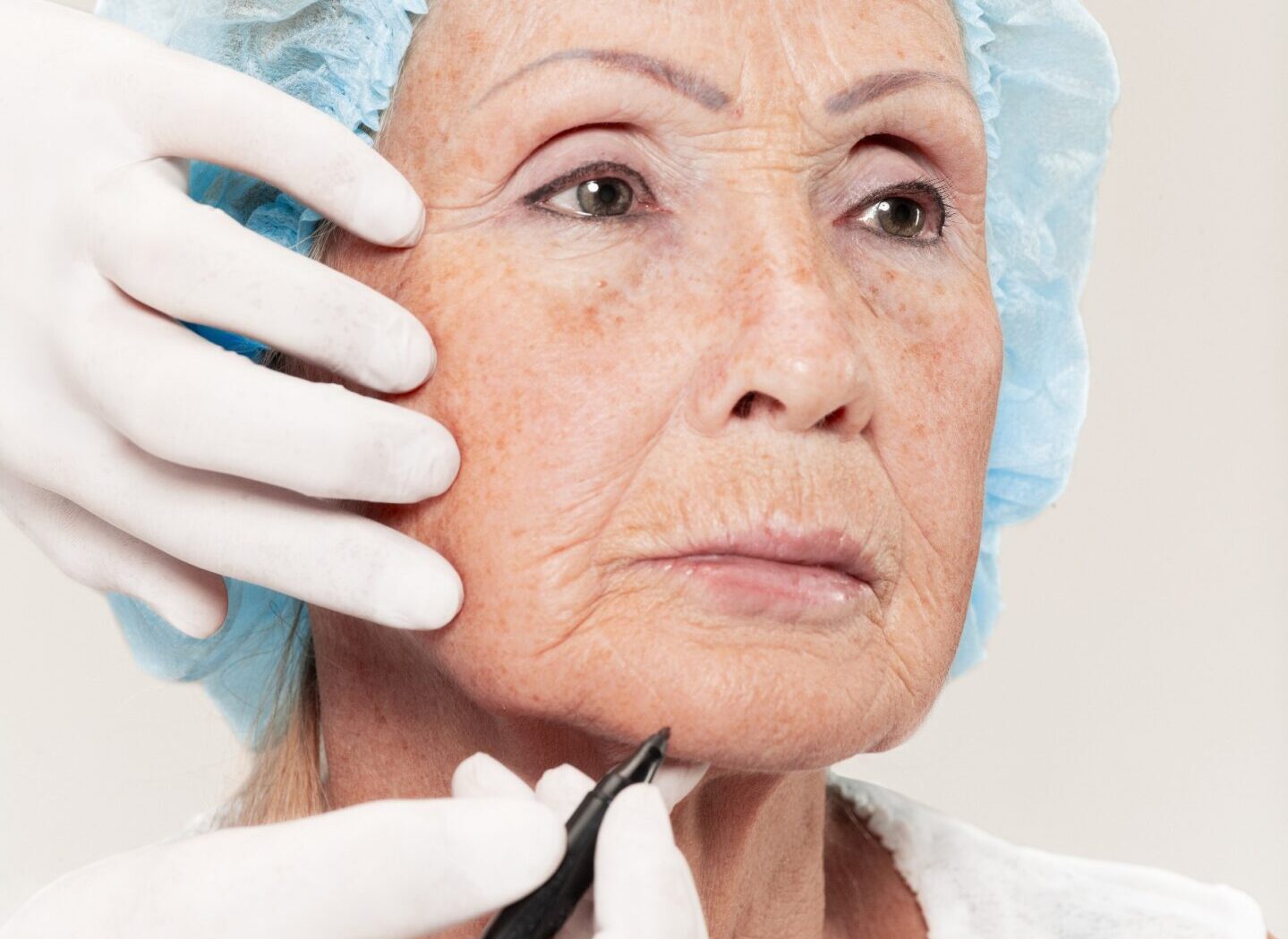 Close-up of a senior woman having her eyebrows permanent makeup done Close-up of a senior woman having her eyebrows permanent makeup done