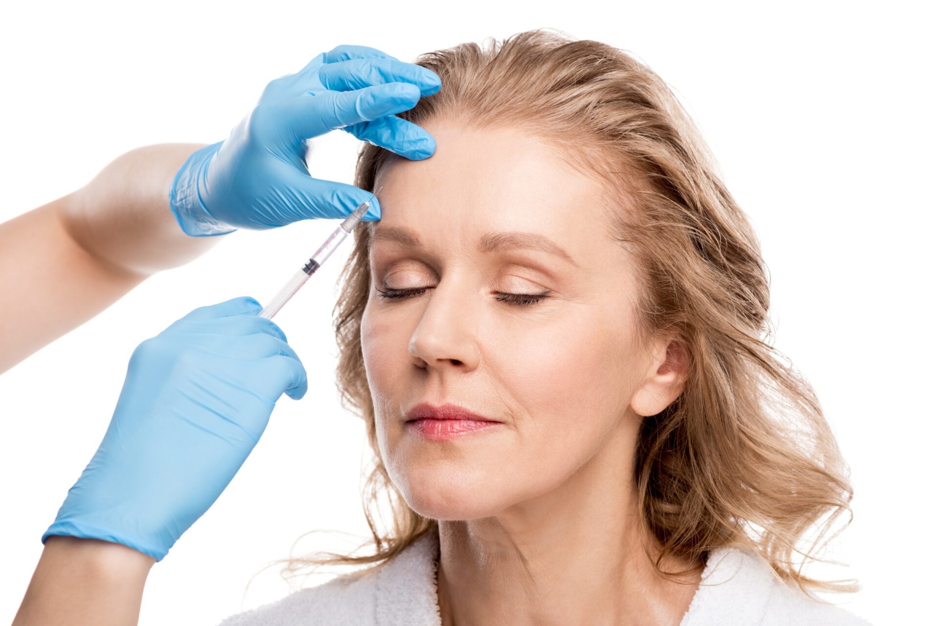 A woman getting her eyebrows examined by a doctor