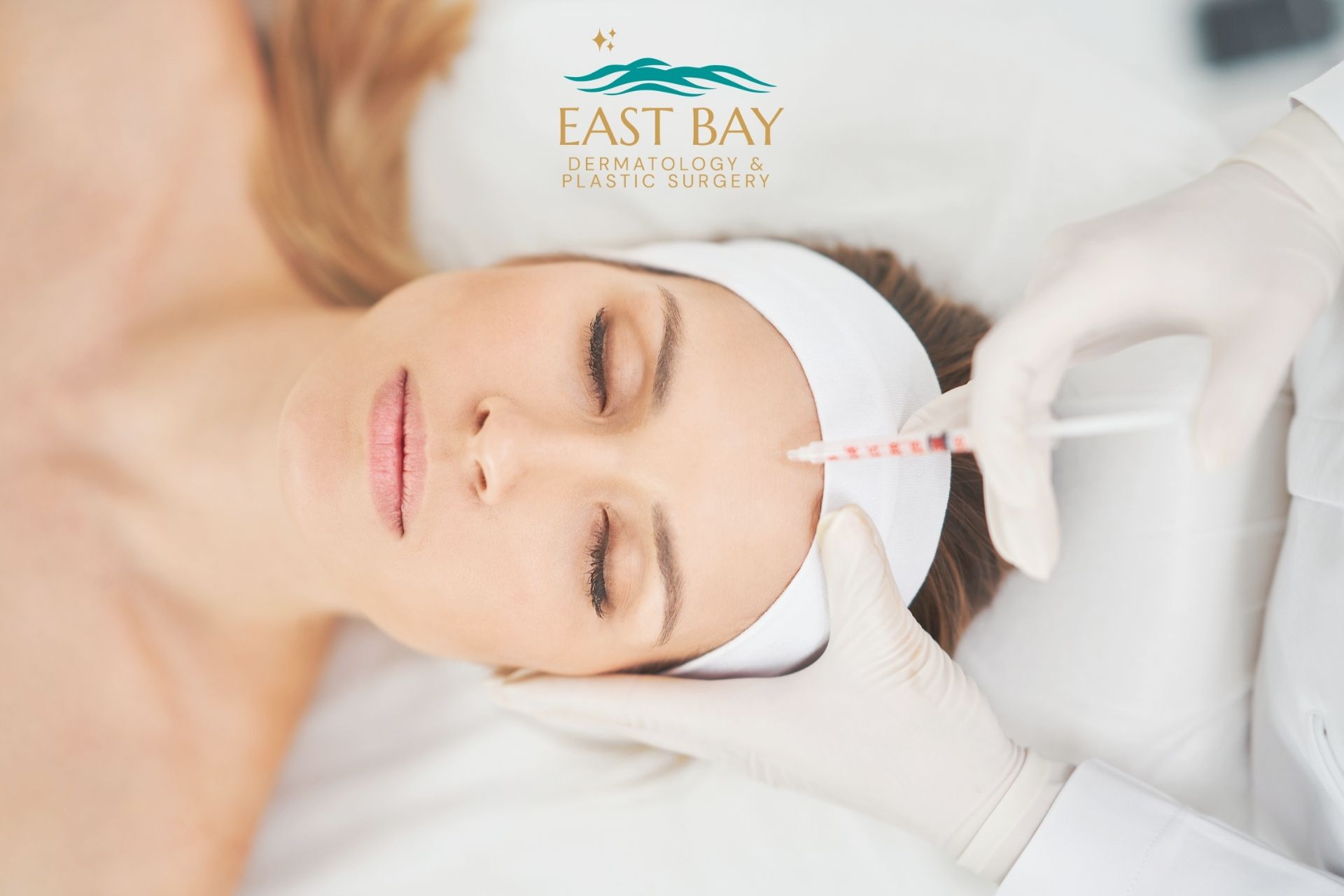 A woman lies with eyes closed while a gloved professional injects her forehead at a medspa in Bellmore; “East Bay Dermatology & Plastic Surgery” logo is at the top.