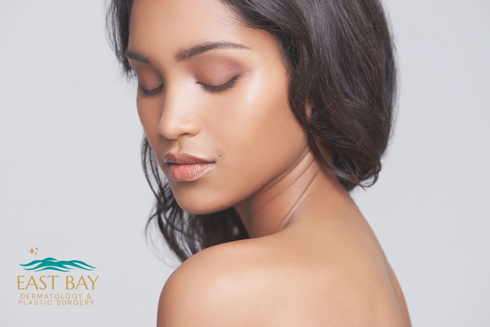 A woman with smooth, glowing skin poses with her eyes closed, showing her side profile—an ideal image of expert skin care in Bellmore. The East Bay Dermatology & Plastic Surgery logo is in the lower left corner.